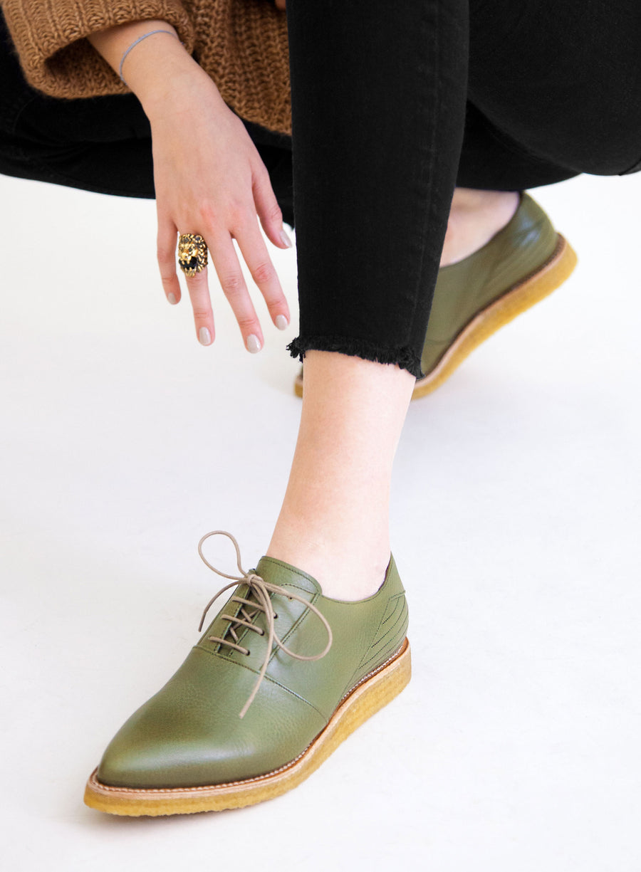 Goodyear welted, olive coloured sustainable flat shoe with a crepe sole  Edit alt text