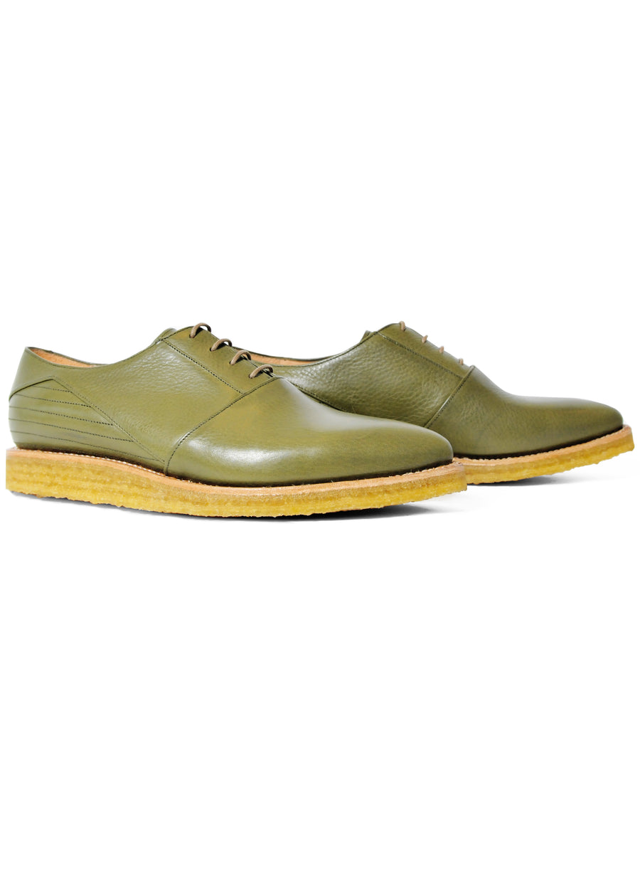 Goodyear welted, olive coloured sustainable flat shoe with a crepe sole  Edit alt text